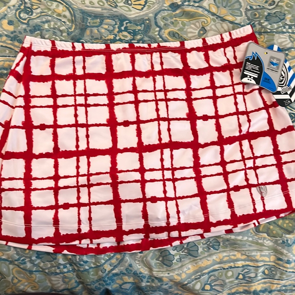 Red and white tennis skirt with ball pocket. Size large